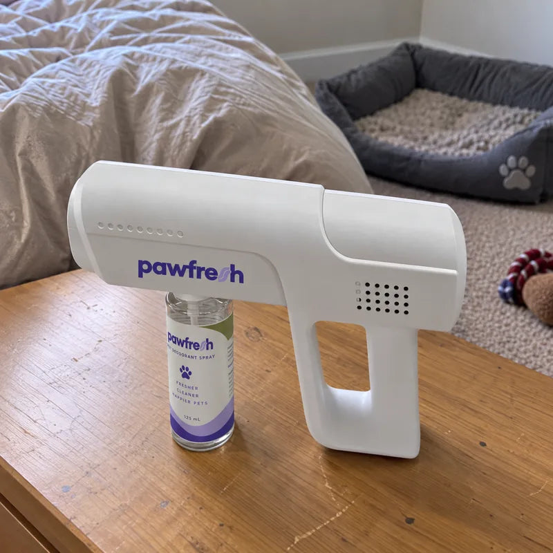 A PawFresh device on a side table next to a dog bed